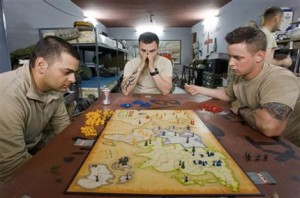 U.S. Army soldiers with the 293D Military Police Company, 97th Military Police Battalion, play board game 'Risk - The Game of Global Domination' as they relax at a local police station on the outskirts of the town of Kandahar, southern Afghanistan 